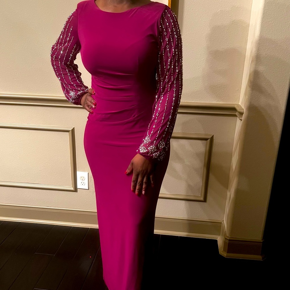 Formal/ semi formal fuschia dress with rhinestone details on sleeves.